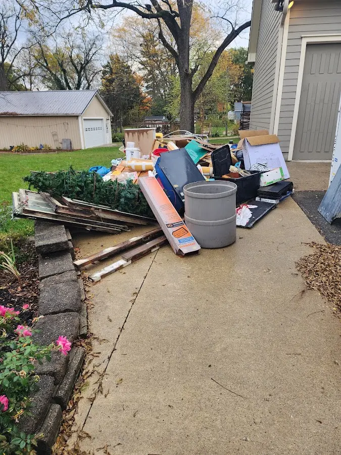 Dumpster being loaded with debris for Commercial Dumpster Rental in Penitas